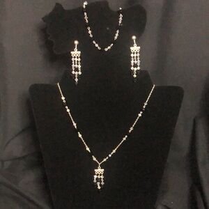 black crystal and silver necklace, bracelet, and clip on earrings